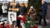 People lay flowers at the grave of Russian opposition leader Aleksei Navalny at the Borisovo Cemetery in Moscow on February 16.