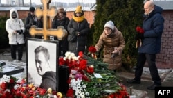 People lay flowers at the grave of Russian opposition leader Aleksei Navalny at the Borisovo Cemetery in Moscow on February 16.