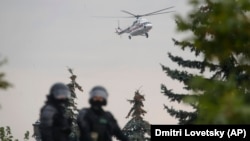 A helicopter believed to be carrying Belarusian President Alyaksandr Lukashenka lands at his residence during a protest rally in Minsk on August 23.