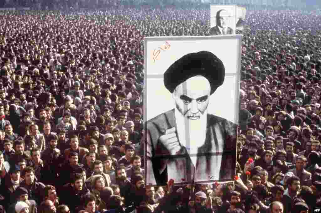 Anti-Shah protests continue to grow as demonstrators hold a poster of&nbsp;Ayatollah Ruhollah Khomeini during mass protests on January 1, 1979.&nbsp; Khomeini had spent 14 years in exile.&nbsp;Cassette tapes of speeches by the 76-year-old Khomeini were smuggled into the country, fueling the unrest.