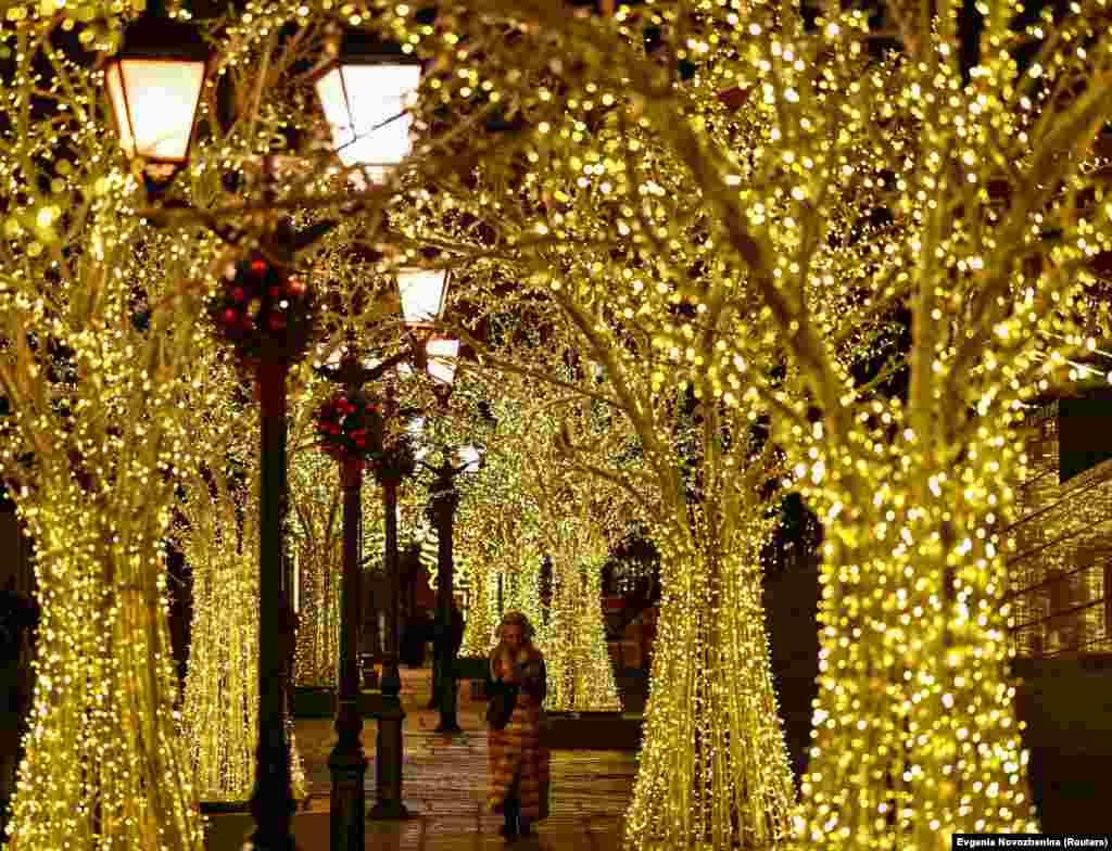 A woman walks past New Year and Christmas decorations in Moscow.