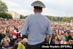 A policeman addresses the crowd at a rally in Minsk on August 20.