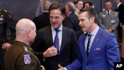 U.S. Secretary of Defense Pete Hegseth (right) speaks with NATO Secretary-General Mark Rutte (center), and NATO's supreme allied commander for Europe, General Christopher Cavoli during an alliance meeting in Brussels last month. 