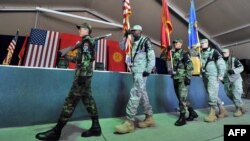 Kyrgyz soldiers parade together with U.S. servicemen during a change of command ceremony at the U.S. transit center at Manas Airport in June. Russia has long been unhappy about the United States' presence in Kyrgyzstan. 