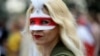 A Belarusian opposition supporter wears a mask during a rally to protest the disputed results of the August 9 presidential election in Minsk on September 6.