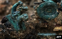 A detail of the Karanovo chariot showing the bronze figurine of a boy riding an unidentified beast