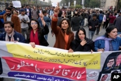 Journalists chant slogans during a protest rally to condemn a new law they call a "black act" in Islamabad on January 28.