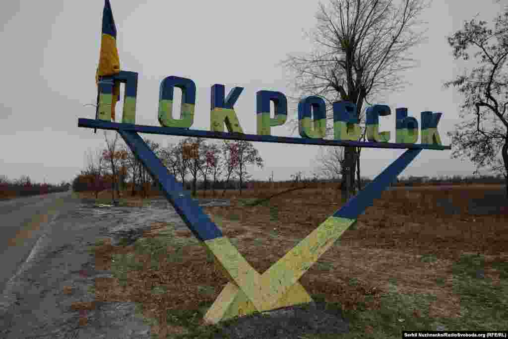 A road sign for Pokrovsk on the outskirts of the city. We leave Pokrovsk with heavy hearts. It seems likely we could return soon to the city to film street battles. We remember the words of shopkeeper Svitlana Yaroslavovna: &quot;I hold on to my faith in God, and the armed forces of Ukraine, this is where I place my hope.&quot;