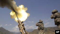 A 155mm round is fired from a Howitzer at insurgents at Forward Operating Base Bostick in Kunar Province on July 8.