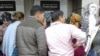 Turkmen migrants stand in line in front of an ATM in Istanbul, Turkey. 