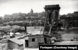 The destroyed Szechenyi Chain Bridge and Buda Castle photographed soon after the siege of Budapest.