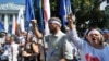 Opposition supporters shout slogans during a protest in front of the Ukrainian parliament in Kyiv on July 30.