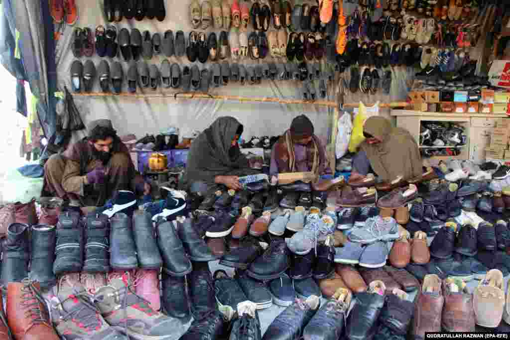 A vendor sells secondhand shoes at a roadside market in Kandahar, Afghanistan.&nbsp;