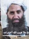 Poster of Taliban spiritual leader Haibatullah Akhundzada along a road in Kabul.