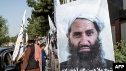 Poster of Taliban spiritual leader Haibatullah Akhundzada along a road in Kabul.