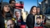 Belarusian opposition leader Svyatlana Tsikhanouskaya, second from right, holds a portrait of her jailed husband Syarhey Tsikhanouski, attend a protest demanding freedom for political prisoners in Belarus in March 2024. 