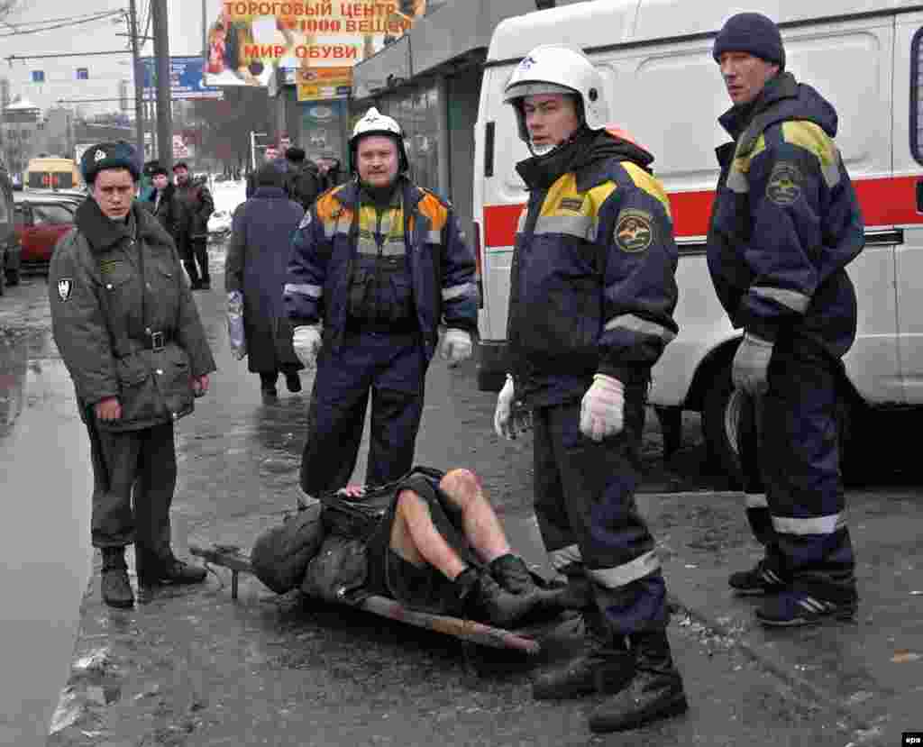 Rescuers attend to a victim evacuated from the metro system.