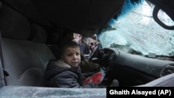 A boy cries after government air strikes in the town of Ariha, in Idlib Province, on January 15.