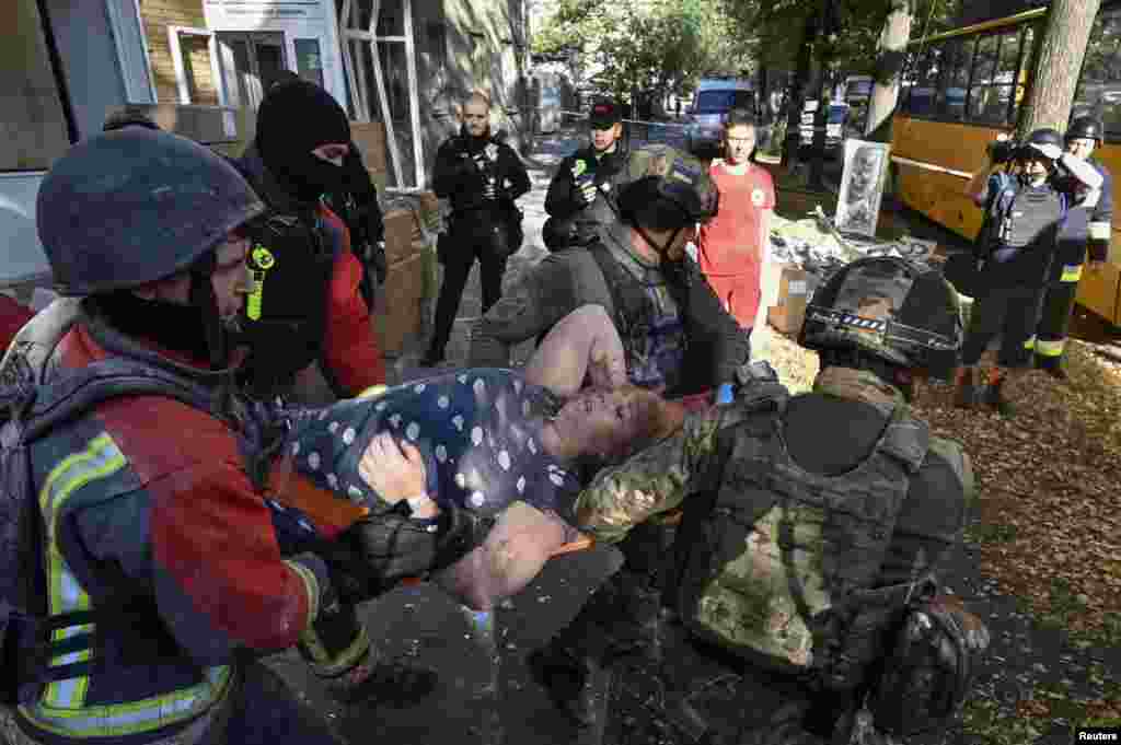 An injured woman being carried out of an apartment block in&nbsp;Zaporizhzhya. Local authorities say the bombs arrived around dawn, when most residents were sleeping.