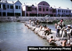 Men and boys washing and swimming in the Kabul River.