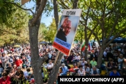 A poster of Russian President Vladimir Putin reading "Putin the president peacemaker" is seen during the annual Russophiles Meet event in Koprinka, near the central Bulgarian town of Kazanlak, in 2019.