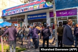 Tajiks queue outside the state air ticket agency in Dushanbe to secure flights to Russia in 2021.