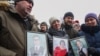 People gather to pay tribute to the victims of a fire at a shopping center in Kemerovo on March 27. 