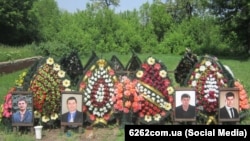 Flowers and photos adorn the graves of priests killed in Sl0vyansk, Ukraine.