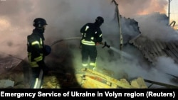 Firefighters work at the scene of a Russian missile strike in Ukraine's Volyn region on November 28.