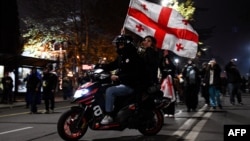 Anti-government protesters rally in the Georgian capital on December 7 for a tenth consecutive day of mass demonstrations against Tbilisi's postponement of EU accession talks. 