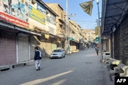 Man walks past a market closed by traders during a strike against sectarian attacks in the Kurram district in November.