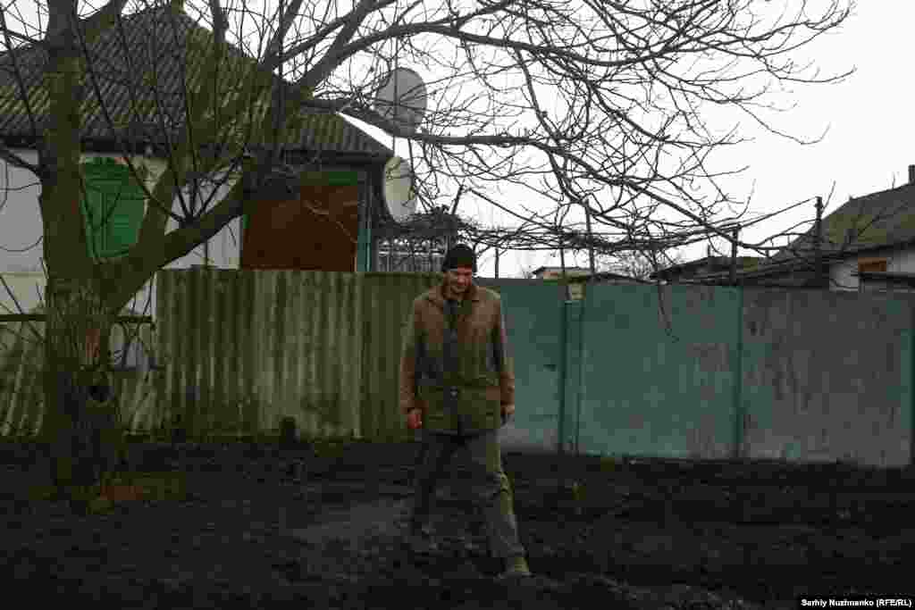 A local resident of the village of Terny, Donetsk region, stands near his house in March 2023. Fighting over the heavily damaged village began in January 2023. It was under full occupation as of early this year.