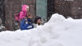 UKRAINE - People walk through a snowdrift during heavy snowfall in the centre of Kyiv on March 1, 2018. 