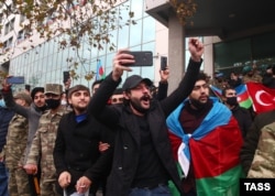 Spectators cheer the parade. The conflict ended in November with a Russian-brokered truce handing swathes of territory to Azerbaijan, prompting celebrations on the streets of Baku.