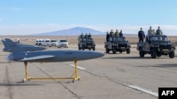 Iranian military officials inspect drones on display prior to a drill at an undisclosed location in central Iran. (file photo)