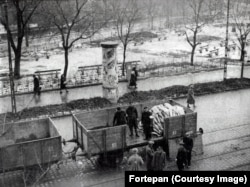 Bodies are transported away from the Budapest Ghetto, where tens of thousands of Jews were held under Arrow Cross rule in the winter of 1944 – 1945.