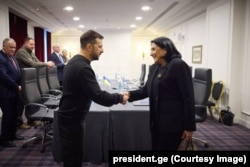 Georgian President Salome Zurabishvili (right) meets with Ukraine's Volodymyr Zelenskiy in Paris on December 7.