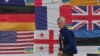 A photo from Kyiv's Independence Square in Kyiv in 2022 shows Ryan Wesley Routh sticking up national flags of the countries helping Ukraine.