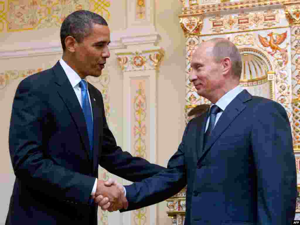 U.S. President Barack Obama and Russian Prime Minister Vladimir Putin shake hands during a meeting at the latter&#39;s country residence home in Novo Ogaryovo, near Moscow, in July 2009.