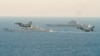 Royal Air Force Typhoons monitor Russian warships the Pyotr Veliky and the Admiral Kuznetsov (rear) as they pass near England on January 25.