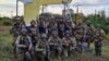 Ukrainian soldiers pose in the recently liberated settlement of Shevchenkove in Ukraine's Kharkiv region on September 10.