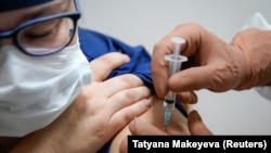 A medic in a regional hospital in Tver receives Russia's Sputnik-V vaccine on October 12. 