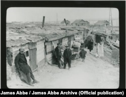 A photograph by James Abbe from 1932, showing youngsters in Ukraine's Zaporizhzhya region standing near their homes, which housed workers involved in building the Dnieper Hydroelectric Station. Completing this massive project, which saw tens of thousands of laborers working in dire conditions, was one of the goals of the first Soviet Five-Year plan.