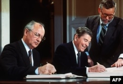 Soviet leader Mikhail Gorbatchev Gorbachev (left) and U.S. President Ronald Reagan sign the INF treaty in Washington in December 1987.