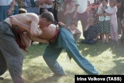 Men wrestling at a festival in Daghestan, Russia, in 1996.