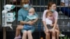 Women hold patients at Kyiv's Okhmatdyt children's hospital after a Russian missile strike on July 8. 