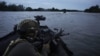 UKRAINE – Ukrainian soldiers navigate on the Dnipro river by boat at the frontline near Kherson, Ukraine, Sunday, June 11, 2023