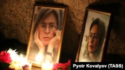 Flowers and candles lie on the Solovetsky Stone in St. Petersburg on October 7, 2019, the 13th anniversary of the assassination of journalist Anna Politkovskaya.