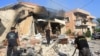 Rescuers inspect the debris at the site of an overnight Israeli strike on a pharmacy in the southern Lebanese village of Akbiyeh on September 24.