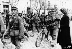 Nazi troops being welcomed by Bulgarians as they arrive in the Balkan country in March 1941.